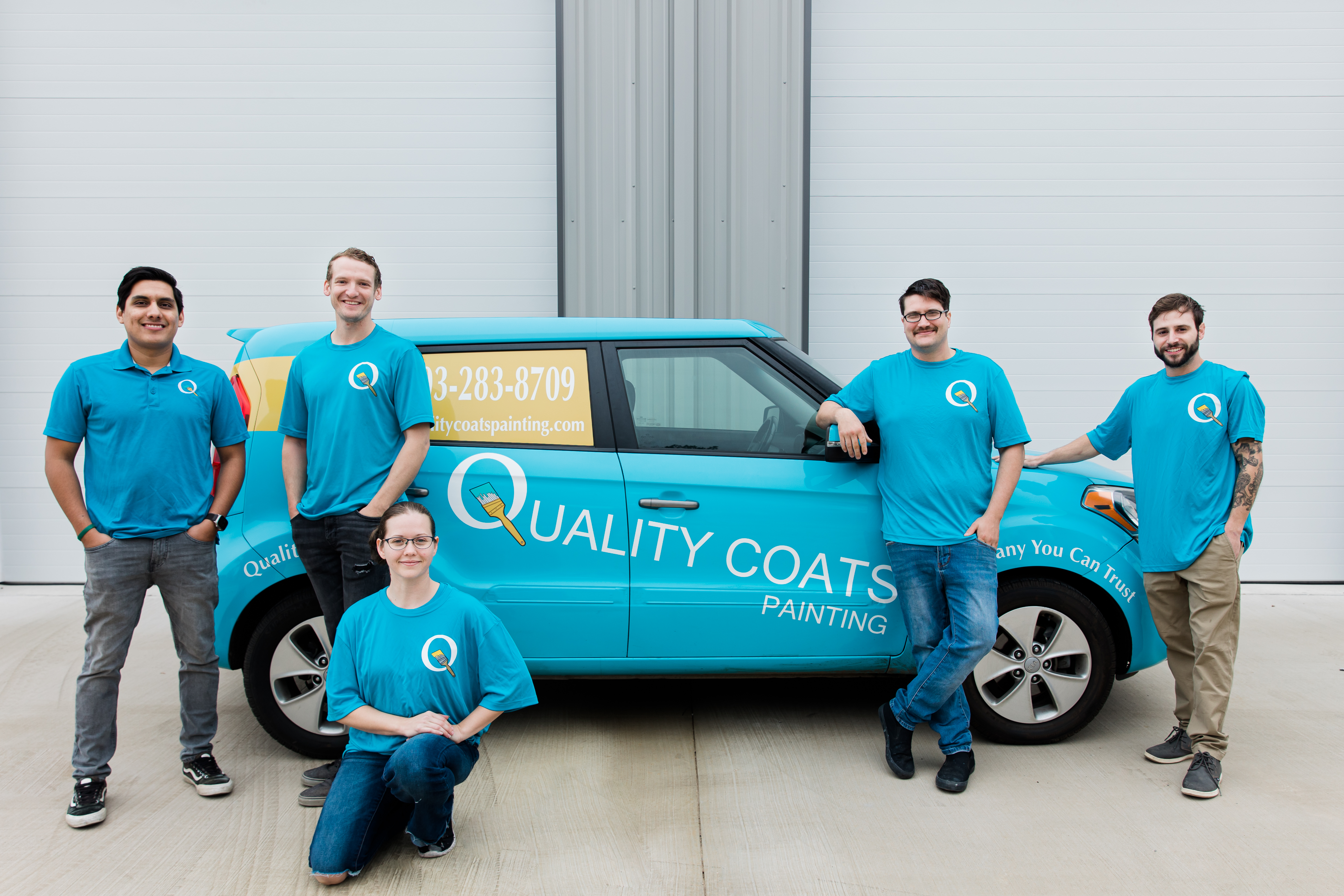 A Picture of the Quality Coats Painting Team along with their wrapped vehicle. We are house painters you can trust