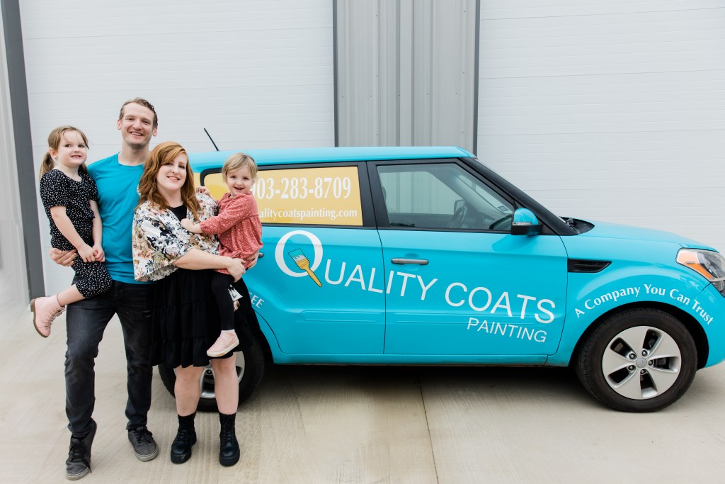 A picture of Hayden Owens (the owner) with Joy Owens (our marketing manager) as well as their children - alongside the company vehicle for Quality Coats Painting, professional house painting company
